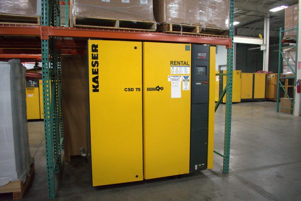 A technician performing air compressor services in a workshop.