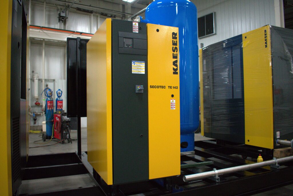 A technician of air compressor services checking parts to maintain efficient operation.