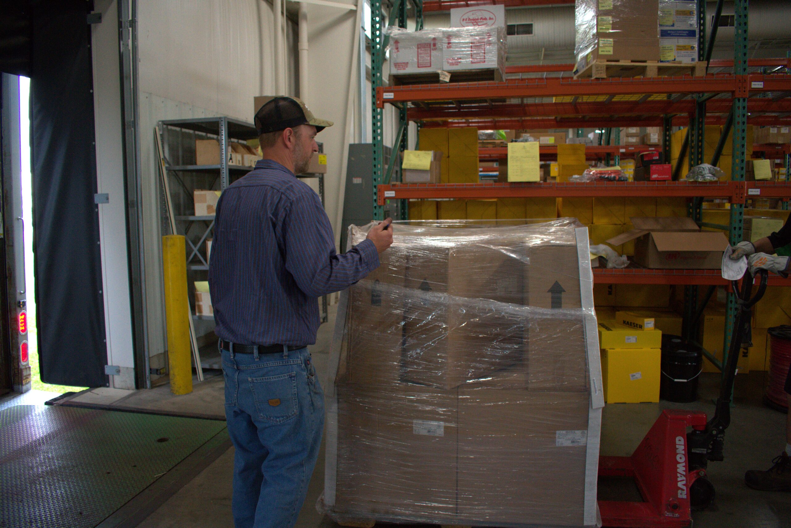 A warehouse worker exemplifying efficient inventory management and workplace safety practices.