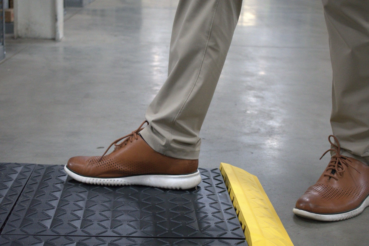 A close-up view of ergonomic matting showcasing its cushioned surface designed to reduce fatigue and improve comfort for employees standing for long